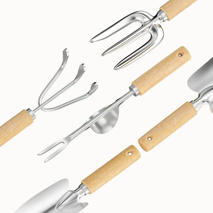Ensemble d'outils de jardinage en inox avec manches en bois, comprenant une fourche, une pelle et un râteau
