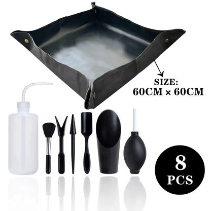 Tapis noir étanche avec accessoires de soin pour jardinage, incluant un arrosoir et divers outils