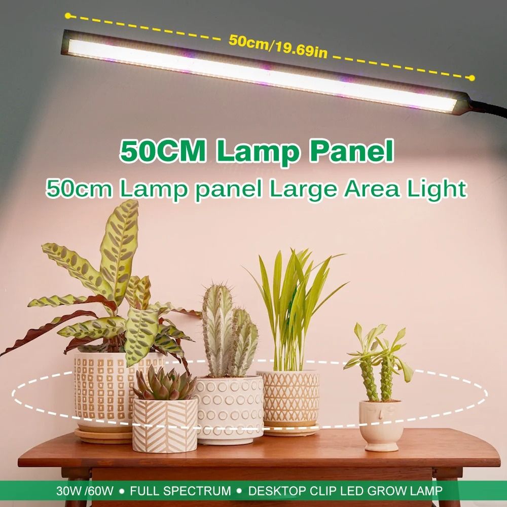 Lampe LED à double tête sur pince éclairant des plantes en pot aux feuilles vertes et décoratives