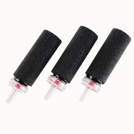 Trois pierres à air cylindriques noires avec embouts transparents et base en plastique visible