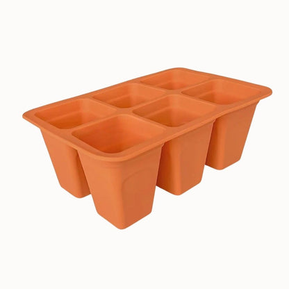 Plateau en silicone orange avec six cellules rectangulaires pour le semis de plantes