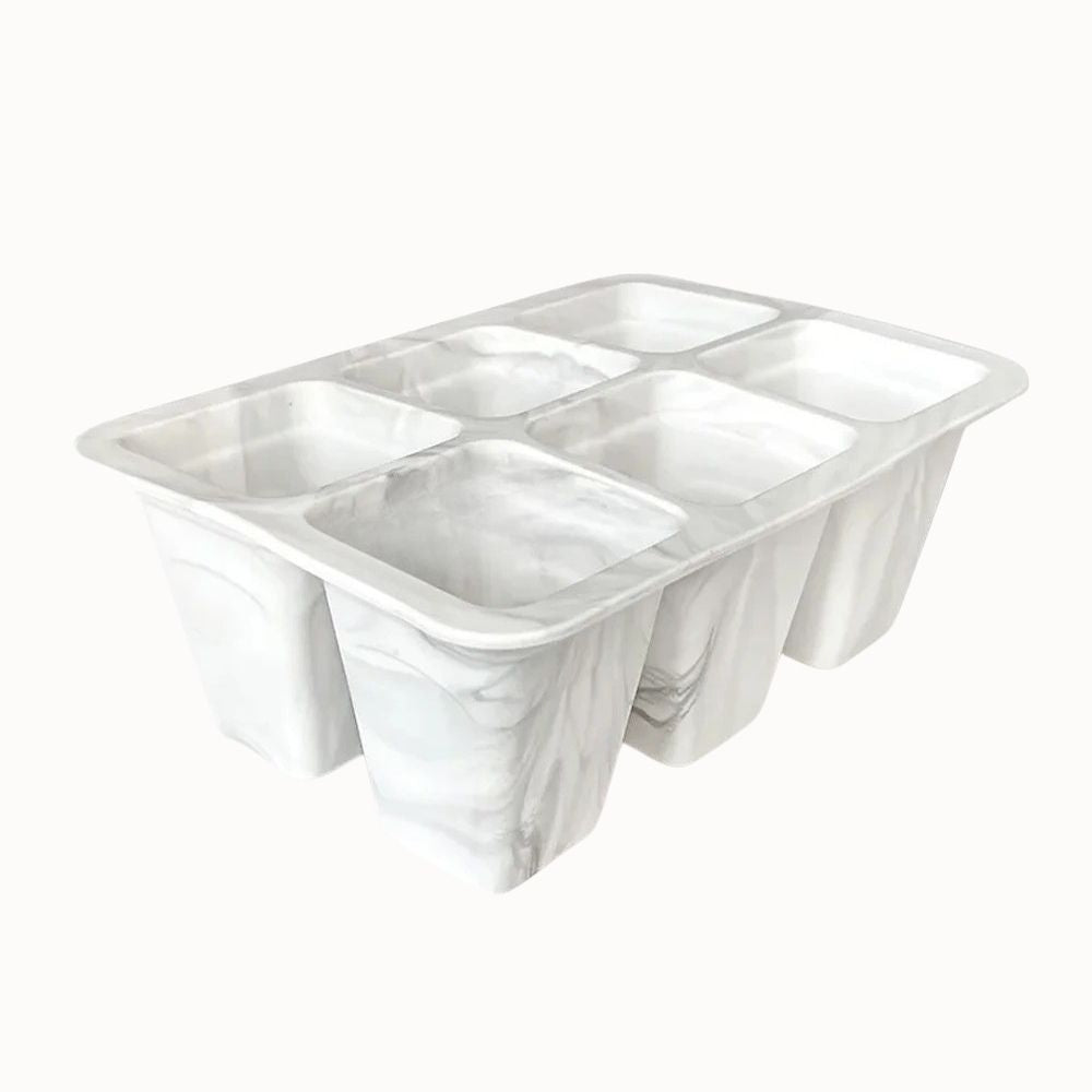 Plateau en silicone blanc marbré avec six cellules pour semis, surface lisse et contours arrondis