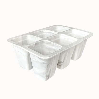 Plateau en silicone blanc marbré avec six cellules pour semis, surface lisse et contours arrondis