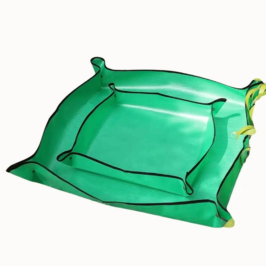 Tapis de rempotage vert en plastique pliable avec des bords noirs et une surface lisse